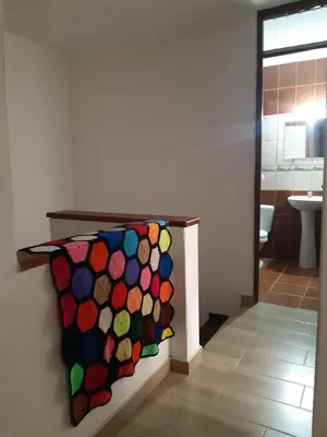 a bathroom with a painting on the wall at Lily House in Ica