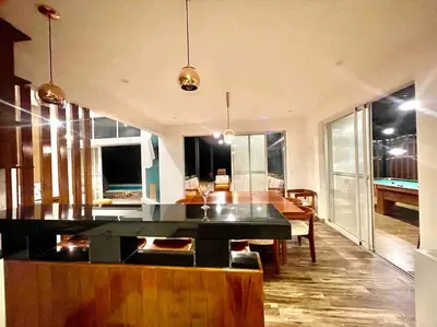 a living room with a table and a dining room at La Finca Ica in Ica