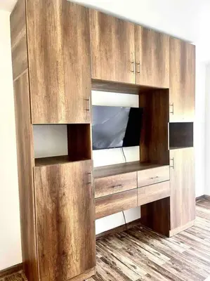 a large wooden cabinet with a tv in it at La Finca Ica in Ica