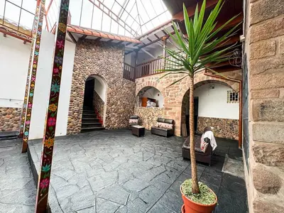 a palm tree in a pot in a lobby at Encanto de Concevidayoc in Cusco