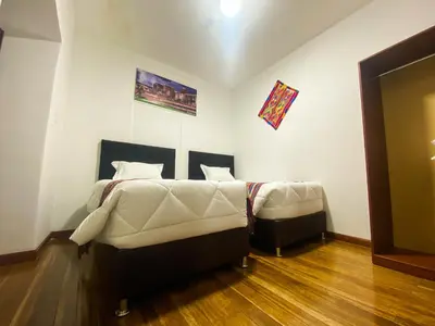 a bedroom with a bed and a couch in it at Encanto de Concevidayoc in Cusco