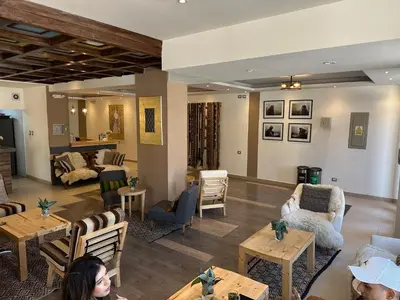 a living room with people sitting at tables at CASA CRISTOBAL Centenario in Cusco