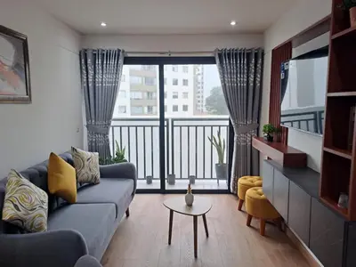 a living room with a couch and a balcony at Departamento Pardo Miraflores in Lima