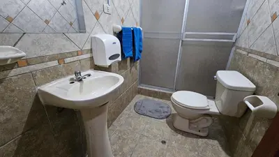 a bathroom with a toilet and a sink at Casa Independiente muy cerca al centro historico - Los Profesionales in Cusco
