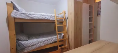 a room with two bunk beds and a table at Departamento cerca al Centro Histórico de Lima in Lima