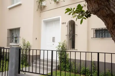 a white house with a black fence at Lima Atelier Boutique in Lima
