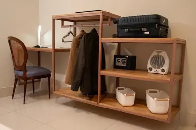 a room with a shelf with a fan and a chair at Lima Atelier Boutique in Lima