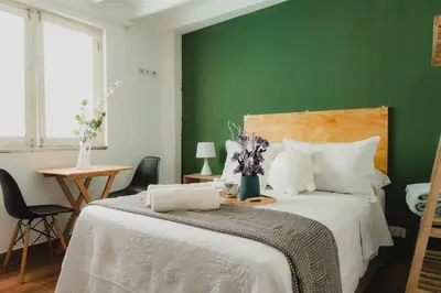 a bedroom with a bed with a green wall at Casa Bellido - Miraflores Private Rooms - Cocina Compartida - Wifi in Lima