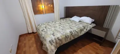 a small bedroom with a bed with two pillows at Departamento completo cerca al Centro Histórico de Lima y al aeropuerto in Lima