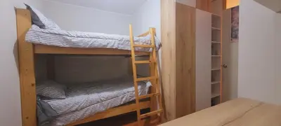 a room with two bunk beds and a closet at Departamento completo cerca al Centro Histórico de Lima y al aeropuerto in Lima