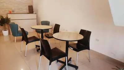 a group of tables and chairs in a room at Mandala Lux Hotel in Pisco