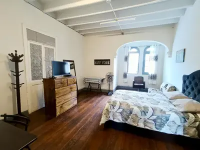 a bedroom with a bed and a dresser with a television at Casona Turística Gonzales in Lima