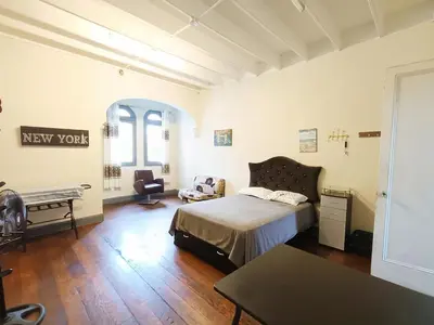 a bedroom with a bed and a chair and a table at Casona Turística Gonzales in Lima