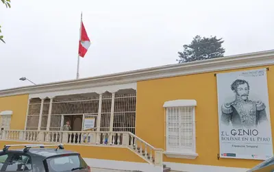 a yellow building with a poster of a man on it at Casona Turística Gonzales in Lima