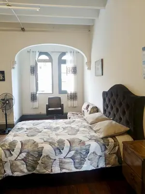 a bedroom with a bed and a chair in it at Casona Turística Gonzales in Lima