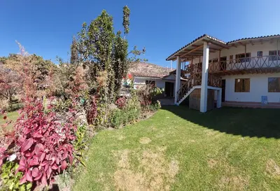 a view of a house with a yard at Hostal Miramonti in Urubamba