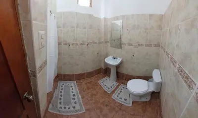 a bathroom with a toilet and a sink at Hostal Miramonti in Urubamba