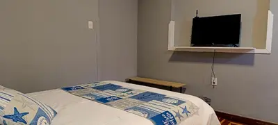 a bedroom with a bed and a flat screen tv at Les Sorciers ooo in Cusco