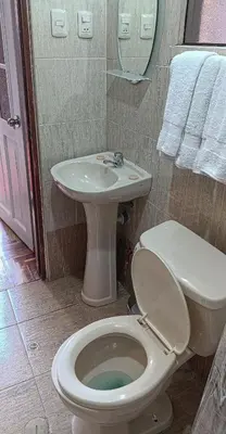 a bathroom with a toilet and a sink at Les Sorciers ooo in Cusco