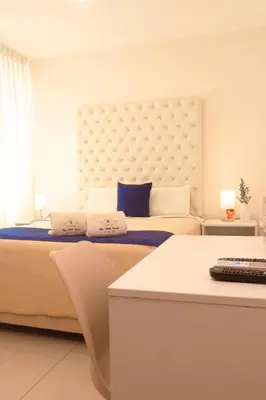 a bedroom with a large bed with a large headboard at Rig Vêda Hotel in Lima