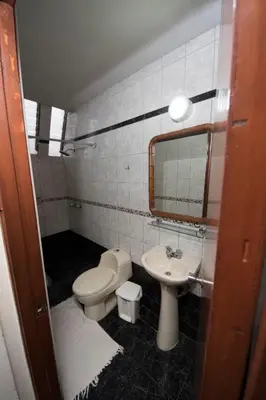 a small bathroom with a toilet and a sink at Casablanca Lima in Lima