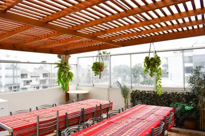 a room with tables and chairs and windows at Casablanca Lima in Lima