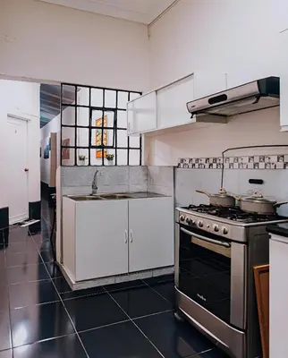 a kitchen with a stove and a sink at Tripper Monkey House Miraflores in Lima