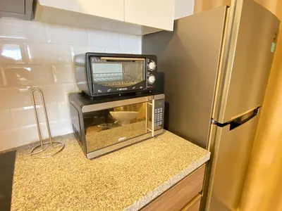 a microwave and a television on a counter in a kitchen at Enjoy Lima in a Renovated and Private Apt D in Lima