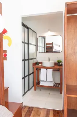 a bathroom with a sink and a mirror at Solara Art House Hotel in Cusco