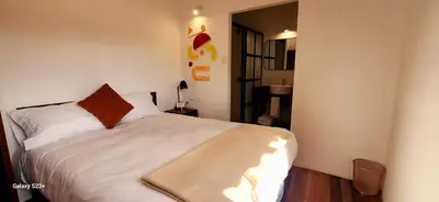 a bedroom with a white bed in a room at Solara Art House Hotel in Cusco
