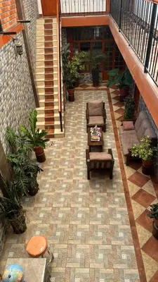 an empty courtyard with chairs and plants in a building at IntiKilla in Mollepata