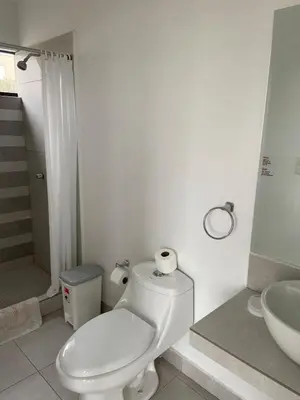 a white bathroom with a toilet and a sink at Casa de Campo en Cieneguilla in Hacienda Cienguilla
