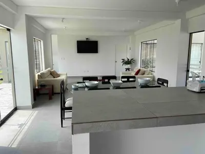 a living room with a couch and a table at Casa de Campo en Cieneguilla in Hacienda Cienguilla
