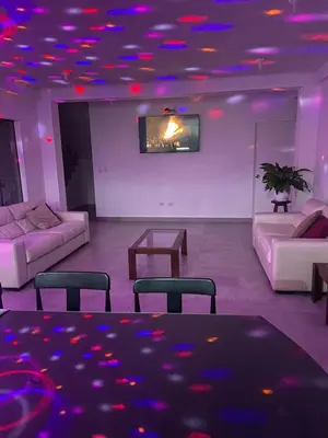 a living room with purple lights on the ceiling at Casa de Campo en Cieneguilla in Hacienda Cienguilla