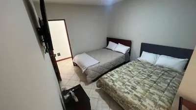 a small room with a bed and a couch at Casa Grande de Campo en Huachipa in Lima