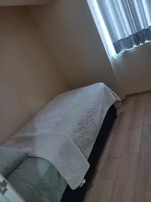 a bed in a small room with a window at Casa Linda San Miguel in Lima