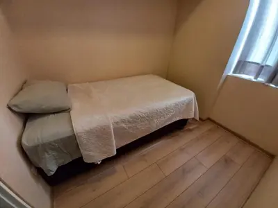 a small bedroom with a bed and a window at Casa Linda San Miguel in Lima