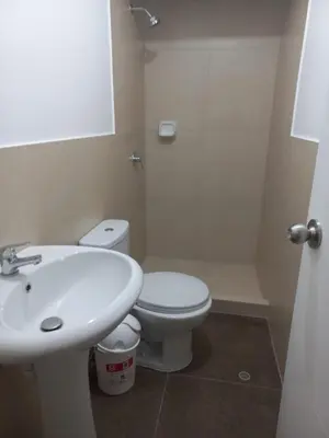a bathroom with a white toilet and a sink at Casa Linda San Miguel in Lima