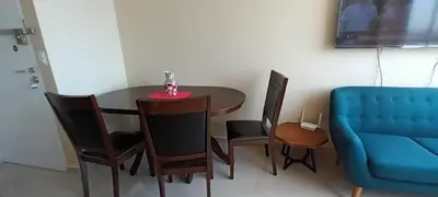 a dining room table with chairs and a blue couch at Casa Linda San Miguel in Lima