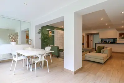 a dining room and living room with a white table and chairs at Mimosas 161 by Wynwood House in Lima