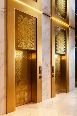 a pair of elevators in a building with gold doors at Nhow Lima in Lima