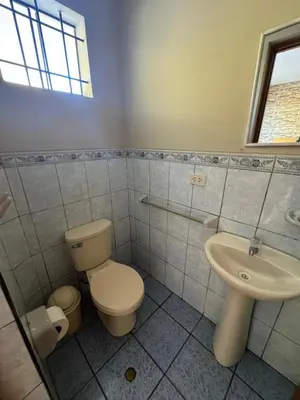 a bathroom with a toilet and a sink at Hotel Alicia in El Puente