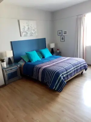 a bedroom with a blue bed with blue pillows at Bonito y Moderno 1 o 2 dormitorios in Lima