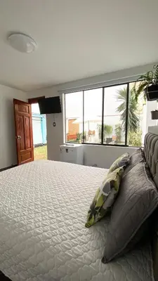a bedroom with a large bed with pillows on it at Hermosa habitación independiente cerca a Miraflores in Lima