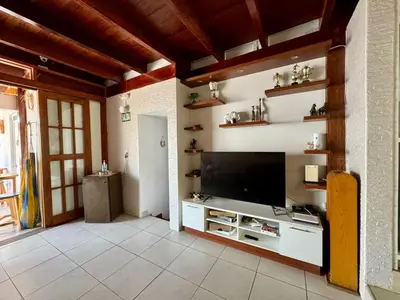 a living room with a flat screen tv on a wall at Surfer Hostel El Quilla Punta Hermosa in Punta Hermosa