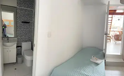 a small bathroom with a bed and a sink at Surfer Hostel El Quilla Punta Hermosa in Punta Hermosa