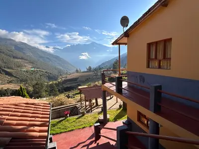 a balcony of a house with a view of a mountain at CASA de SALCANTAY , Choquequirao in Cachora