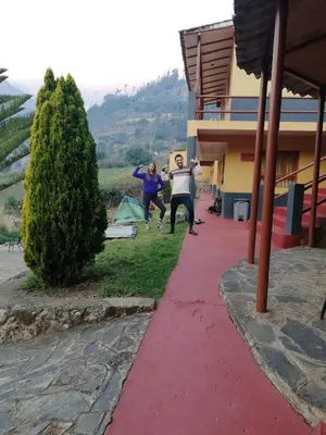 a group of people jumping off a red sidewalk at CASA de SALCANTAY , Choquequirao in Cachora