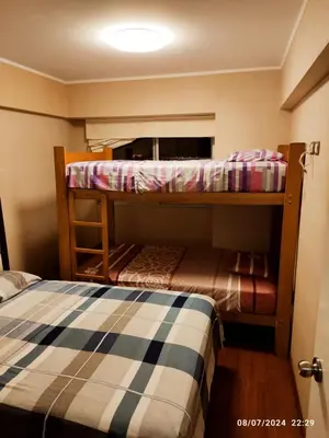 a room with two bunk beds and a bed at Adriane in Lima