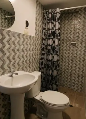 a bathroom with a toilet and a sink at Aqquazul Hospedaje Ayacucho in Ayacucho